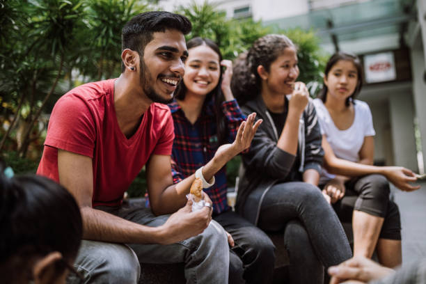 istockphoto-987130494-612×612 Multi Ethnic Group Of Students Joking And Getting To Know Each Other Better On Lunch Break in University Yard